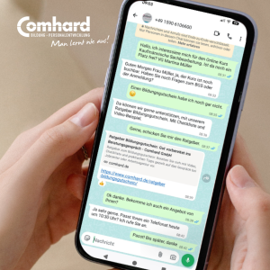 Hand hält ein Smartphone mit einem WhatsApp-Chat zur Beratung über eine kaufmännische Online-Weiterbildung und den Bildungsgutschein bei Comhard.